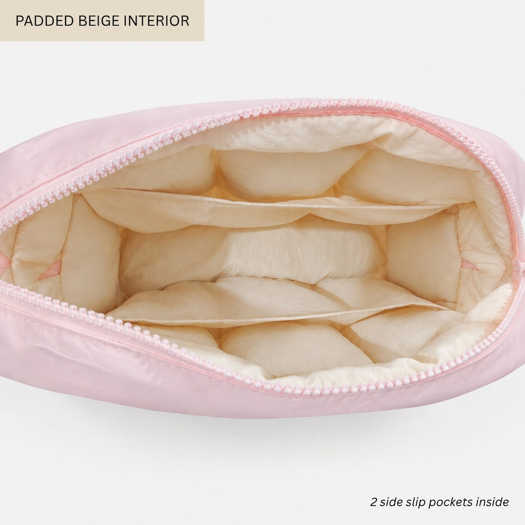 A light pink zippered pouch shown open to display its padded beige interior, with text labels reading 'PADDED BEIGE INTERIOR' and '2 side slip pockets inside' on a clean white background.